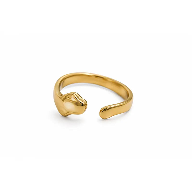 Gold color ring with a unique design on a white background