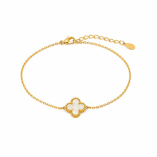 Gold color  bracelet with a central pearl on a white background