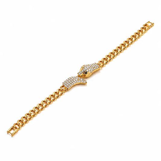 Gold chain bracelet with lion head design on a white background