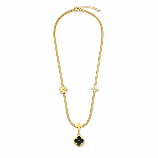 Gold-tone clover pendant chain necklace with black floral charm and elegant minimalist design for women.