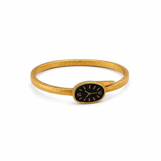 Gold bracelet with a black face on a white background