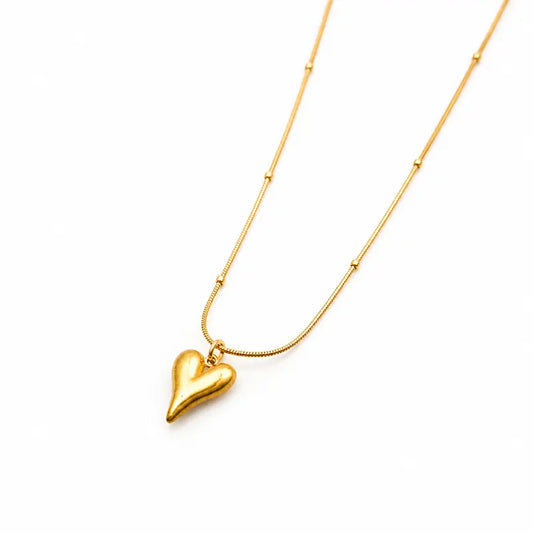 Gold heart-shaped pendant necklace on a white background