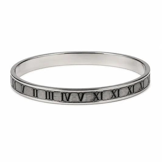 Silver bracelet with Roman numeral engraving on a white background