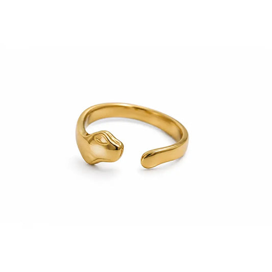 Gold color ring with a unique design on a white background